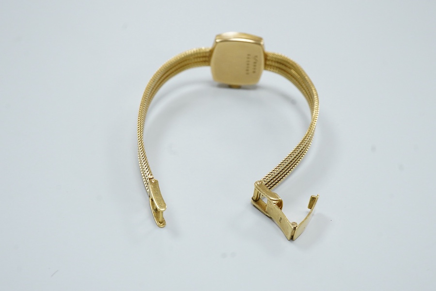 A lady's modern 18ct gold Cortebert manual wind wrist watch, with baton numerals, on 18ct gold integral strap, case diameter 18mm, overall length 17.7cm, gross weight 22 grams.